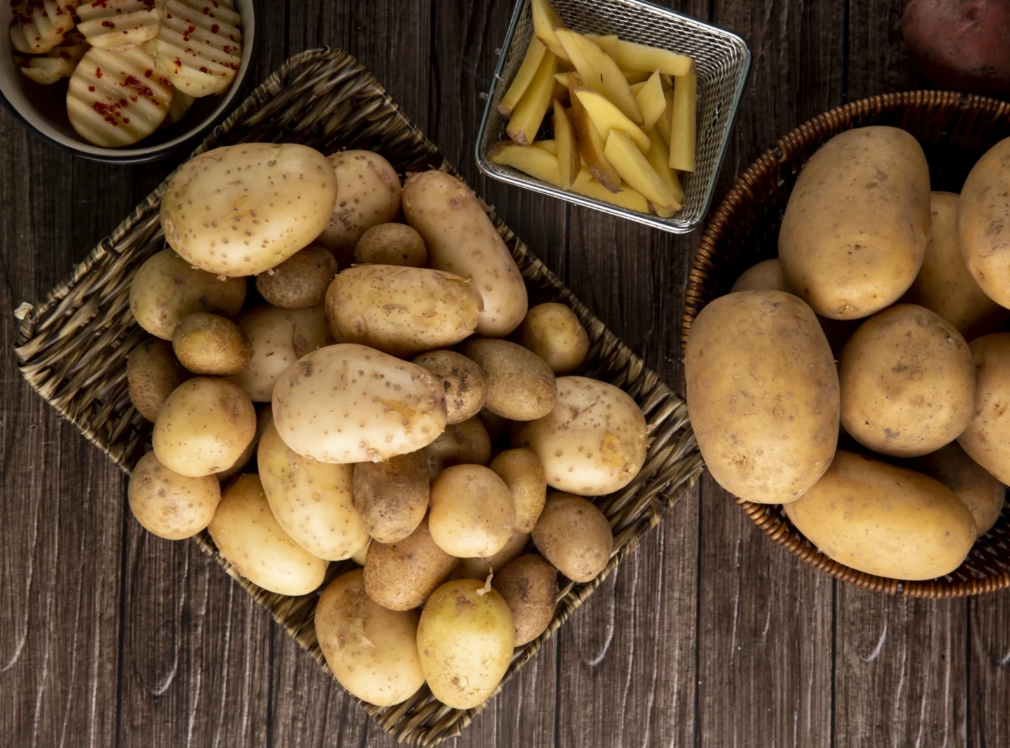 top-view-young-potatoes-basket-wooden-background
